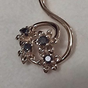 14K floral pendant set with 4 Blue Diamonds